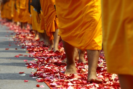 Buddhists walk on petals